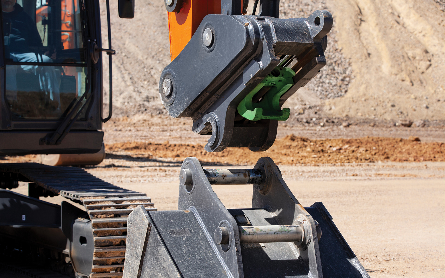 The hydraulic quick coupler on the DTL35 compact track loader attaching to a bucket.