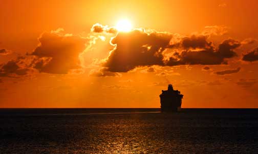Large ocean liner on open ocean during sunset