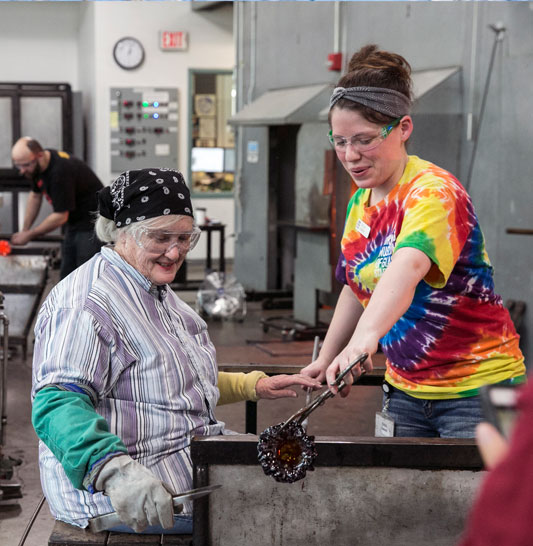 Women blowing glass in Corning, NY