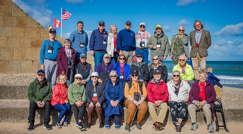 A group photo in front of the Signal Monument at Omaha Beach