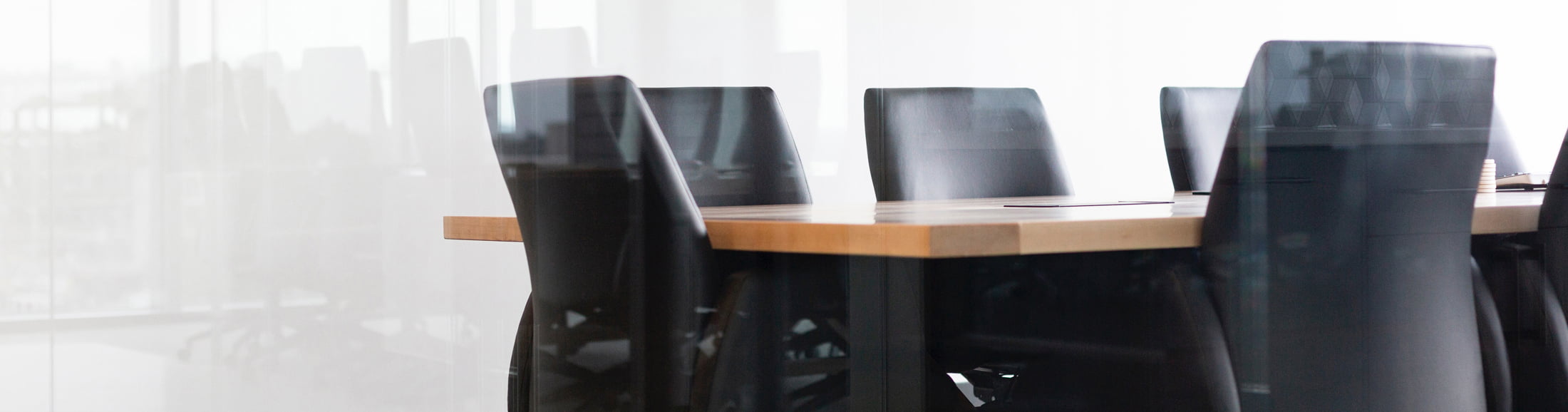 Empty boardroom with large conference table, representing resources for board directors