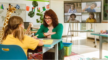 teacher helping student in classroom