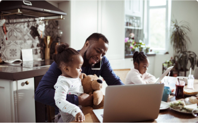 Father working at home with his daughters