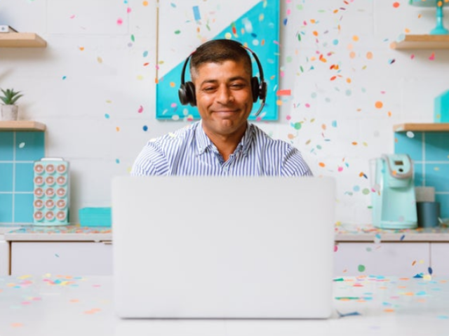 Man celebrating at desk Man celebrating at desk