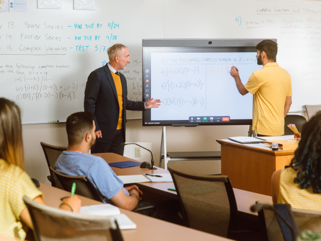 professor and student at whiteboard professor and student at whiteboard