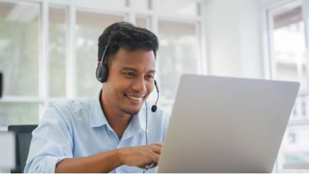 man smiling at computer