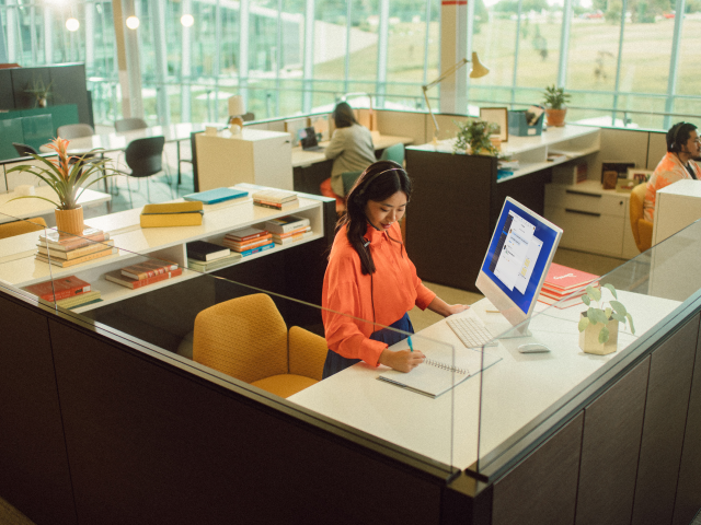 Woman writing at office desk Woman writing at office desk